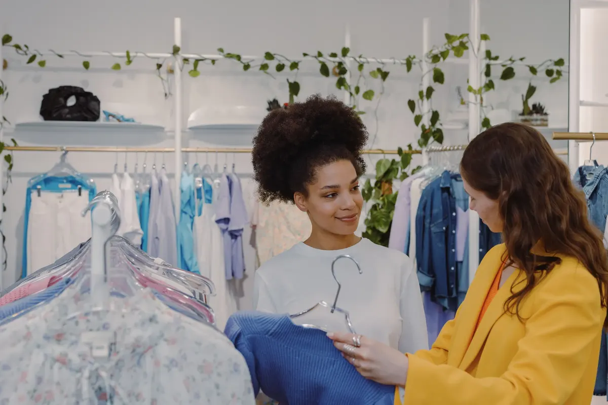 Two women choosing clothes in a store