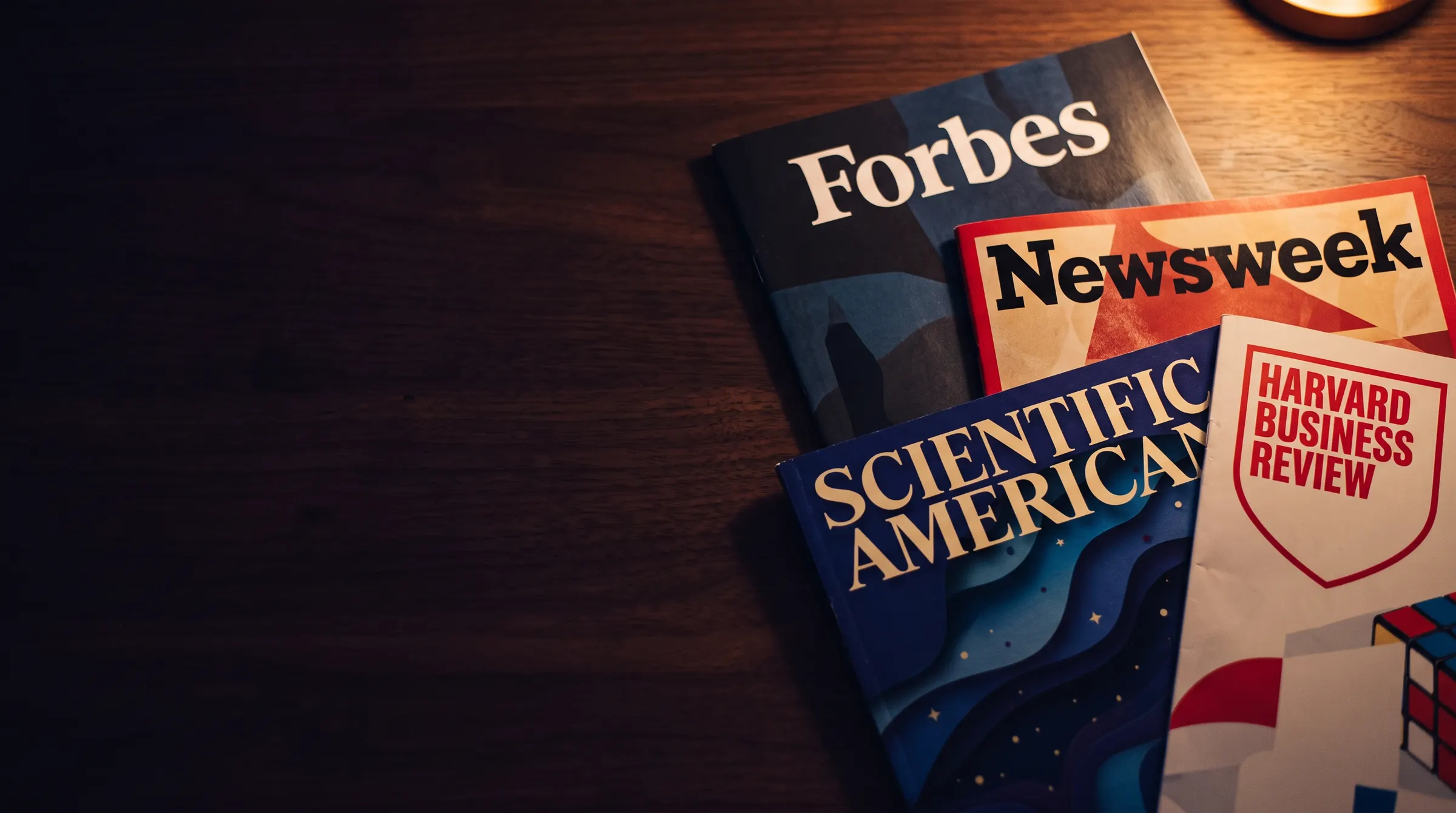Copies of Forbes, Newsweek, Scientific American and Harvard Business Review on a table