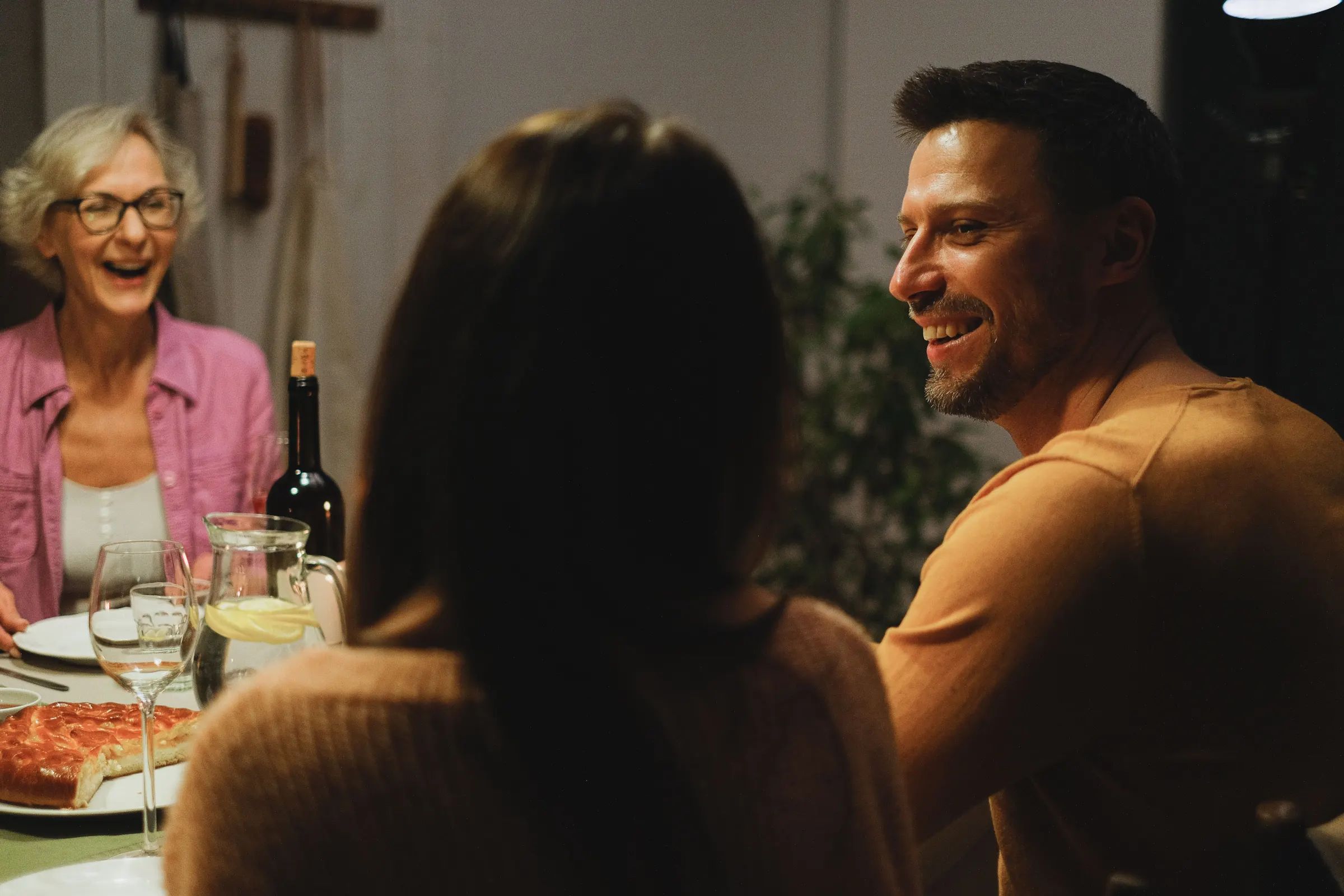 Friends laughing together over dinner